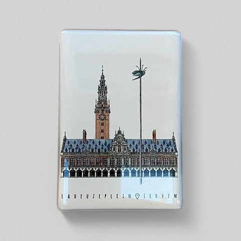 Epoxy fridge magnet featuring a detailed illustration of Leuven’s iconic square, Ladeuzplein with the text “LAdeuzeplein • Leuven” on a glossy rectangular surface