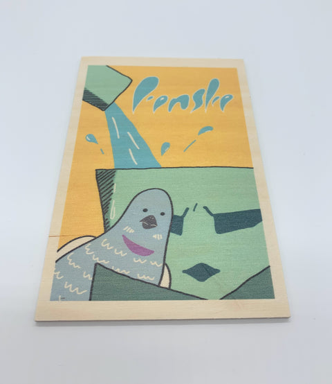 A decorative wooden accessory featuring an illustration of Leuven’s iconic Fonske statue with pigeons.