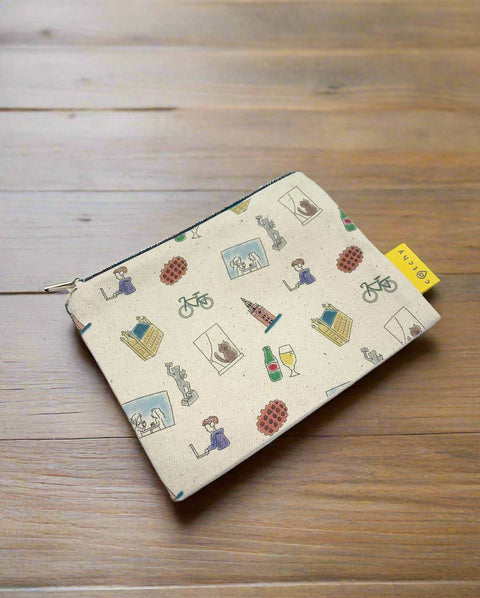Handmade mini zipper pouch made from 100% cotton, featuring a pattern with small symbols representing Leuven. Compact and lightweight, perfect for storing keys, money, earphones, and other small essentials