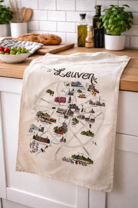 Tea towel with a map of Leuven hanging on a kitchen cabinet.