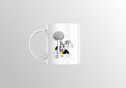 White ceramic mug featuring a whimsical black-and-yellow illustration of a girl relaxing under a tree near Leuven’s City Park, with a coffee bottle and book by her side