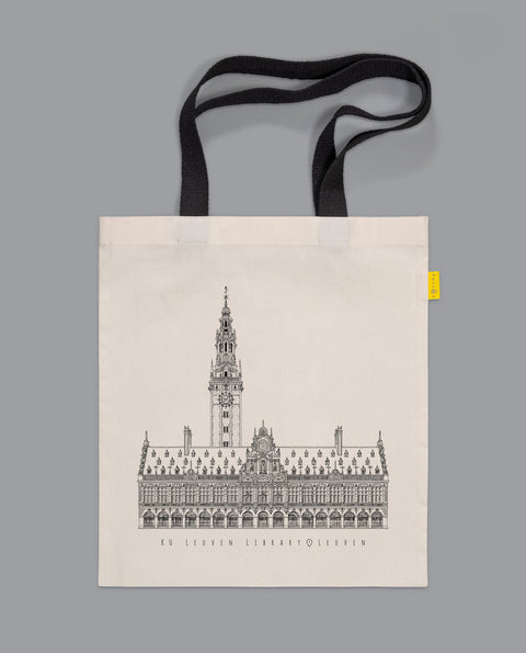 A canvas tote bag with black handles features a line art illustration of Leuven’s heritage KU Leuven library.