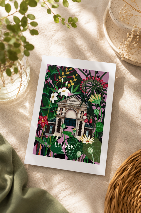 A printed art card or postcard featuring an illustrated classical building surrounded by lush tropical foliage, placed on a beige surface with soft natural shadows. The postcard has a white border and the text 'LEUVEN' and 'Flanders Belgium' visible on the artwork.