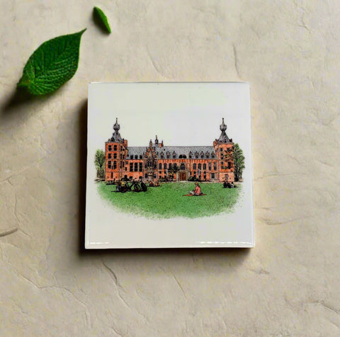 Ceramic coaster featuring a detailed illustration of the Arenberg Castle on a glossy white background.