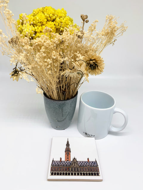 Ceramic coaster featuring a detailed illustration of the University Library and tower on a glossy white background.