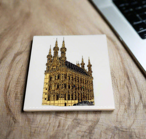 Ceramic coaster featuring a detailed illustration of Leuven’s historic Old Town Hall on a glossy white background.