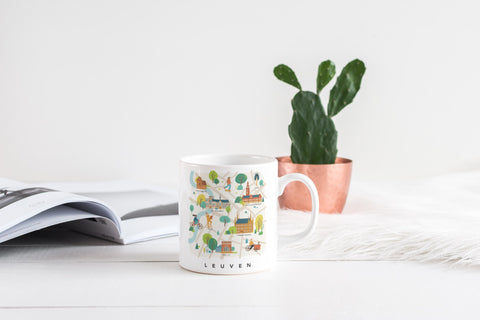 Ceramic mug featuring a playful illustration of the Leuven map with city icons. Dishwasher and microwave safe, measuring 8 cm in diameter and 9.5 cm in height.