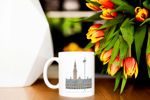 White ceramic mug featuring an illustrated design of Leuven’s Ladeuzeplein with the University Library and iconic beetle on a pole.