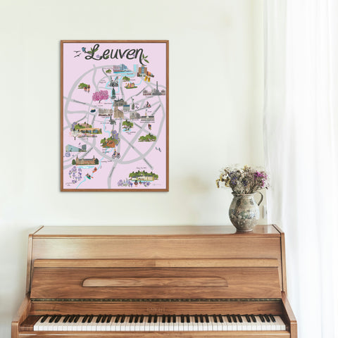 Dutch-language poster featuring a colorful illustrated map of Leuven with key landmarks, parks, and attractions, displayed on a modern white wall.