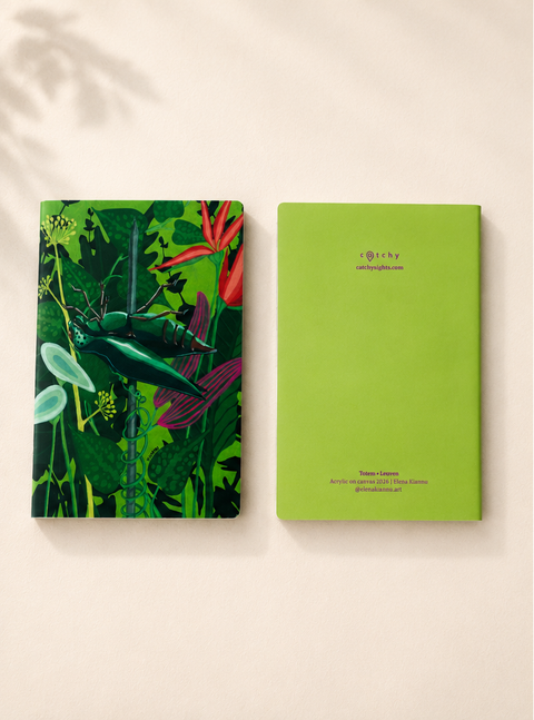 A notebook with TOTEM illustration, displayed side-by-side on a warm beige background. The left notebook features a detailed tropical jungle illustration with a green dragonfly and red flowers.