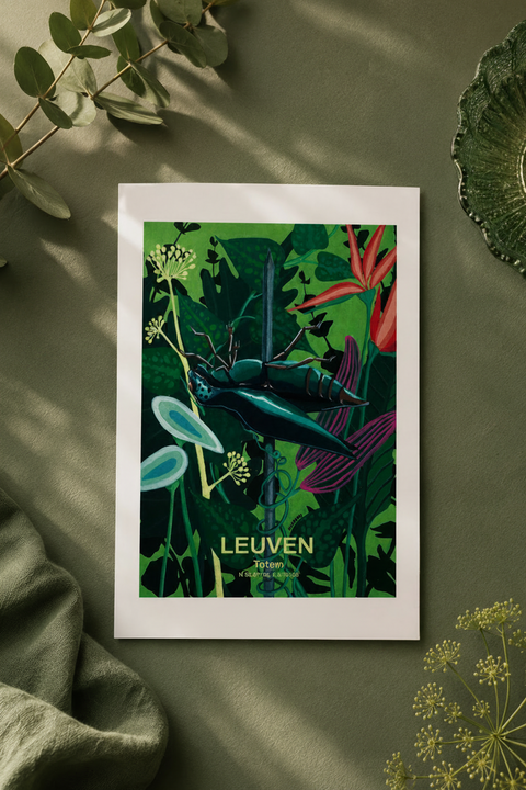 A white framed postcard of Leuven, featuring a vintage-style illustration of a bluebottle fly among lush green foliage and red flowers, styled on a textured olive green surface with eucalyptus leaves