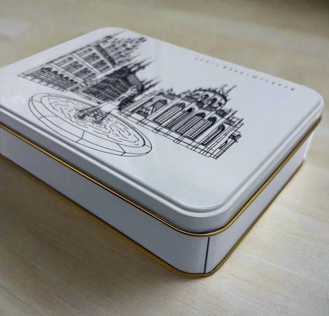 A rectangular metal tin box with a black line of art illustration of Leuven’s Grote Markt features the Town Hall, Fonske fountain, and Saint Peter’s Church on the lid.