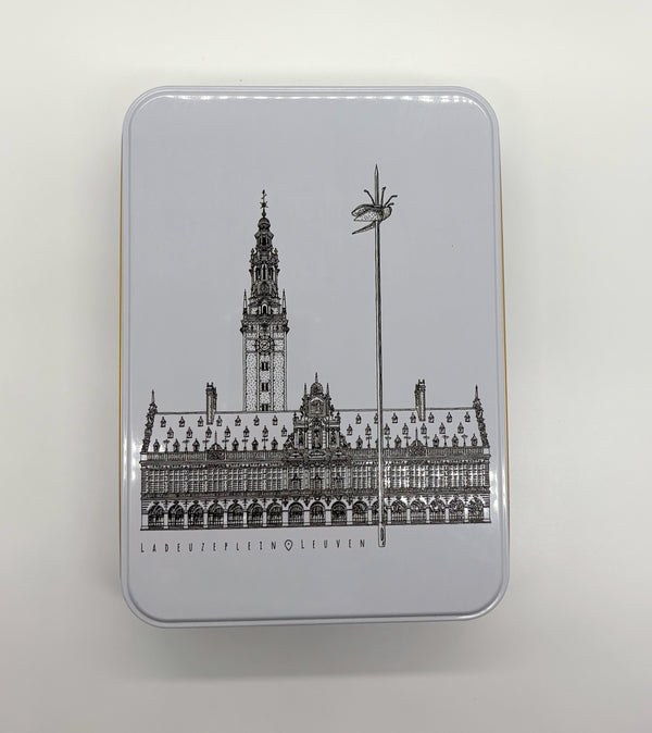 A rectangular metal tin box with a black line of art illustration of Leuven’s 
iconic landmark, OLD own Hall,  on the lid.
