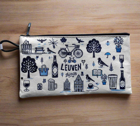 Vinyl leather zipper pouch with playful blue and black illustrations of Leuven icons, including bikes, houses, trees, drinks, and the phrase “Leuven things” on a cream background