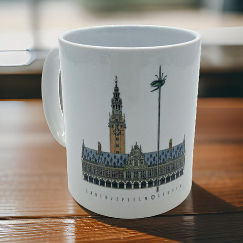 White ceramic mug featuring an illustrated design of Leuven’s Ladeuzeplein with the University Library and iconic beetle on a pole.