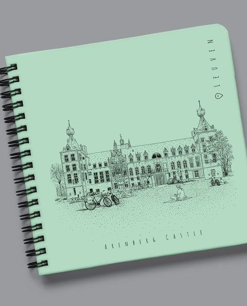 Spiral-bound Leuven notebook featuring Arenberg Castle and KU Leuven Library designs. Sturdy hardcover with durable metal binding and 80 acid-free blank pages. Compact 15x15 cm size, perfect for sketching, writing, or note-taking. A stylish and practical gift for Leuven lovers, students, and creatives.