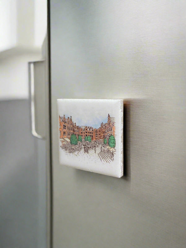 Ceramic fridge magnet featuring a detailed illustration of Leuven's iconic landmark, Oude Markt.  