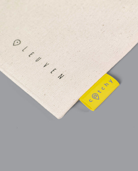 The canvas zipper pouch features a minimalist line drawing of the Fonske statue in Leuven, with "Leuven" and Catchy branding.